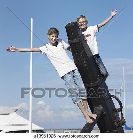 Boys climbing on pier View Large Photo Image Stock Photograph - Boys climbing on pier. Fotosearch