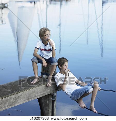 Boys eating ice cream on pier View Large Photo Image Stock Image - Boys eating ice cream on pier. Fotosearch