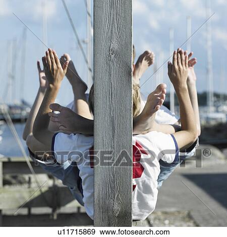 Stock Photo - Boys sitting together on pier. Fotosearch