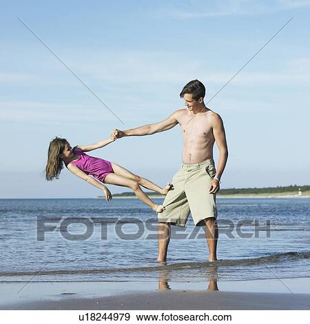 Brother and sister playing on beach View Large Photo Image Stock Photo - Brother and sister playing on beach. Fotosearch