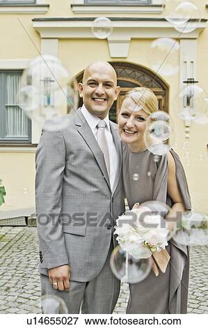 Bubbles framing newlywed couple View Large Photo Image Stock Photo - Bubbles framing newlywed couple. Fotosearch