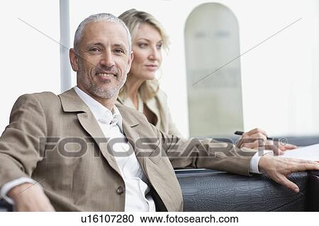 Business people sitting in lobby area View Large Photo Image Stock Image - Business people sitting in lobby area. Fotosearch