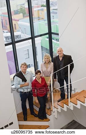 Stock Photography - Business people smiling on stairs. Fotosearch