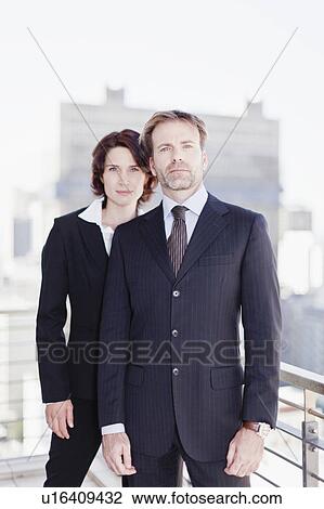 Stock Image - Business people standing in office. Fotosearch