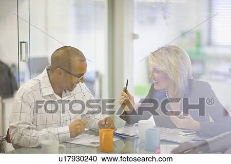 Stock Image - Business people talking in conference. Fotosearch