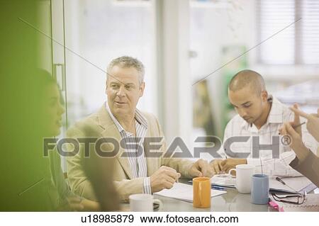 Stock Photo - Business people talking in conference. Fotosearch