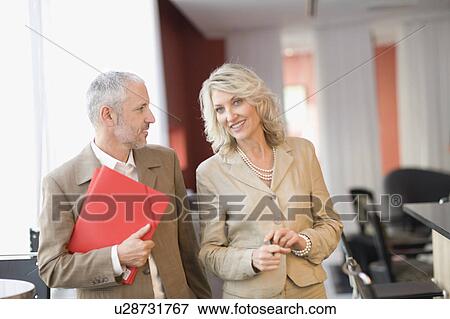 Business people talking in lobby area View Large Photo Image Stock Photo - Business people talking in lobby area. Fotosearch