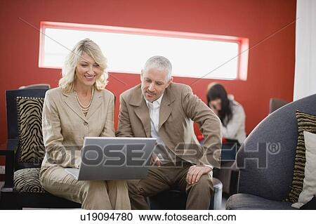 Business people using laptop in lounge View Large Photo Image Stock Image - Business people using laptop in lounge. Fotosearch