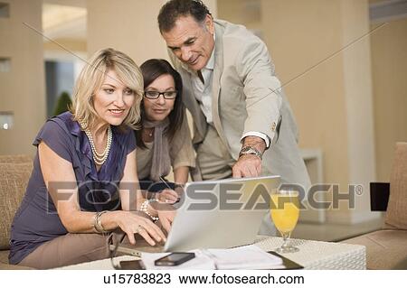 Stock Image - Business people working in lounge. Fotosearch