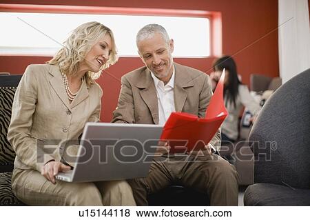 Business people working in lounge View Large Photo Image Stock Photo - Business people working in lounge. Fotosearch