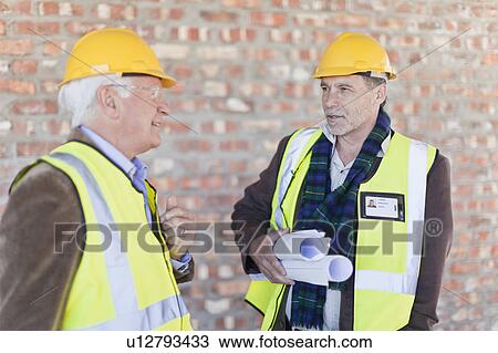 Businessman and worker talking on site View Large Photo Image Stock Image - Businessman and worker talking on site. Fotosearch
