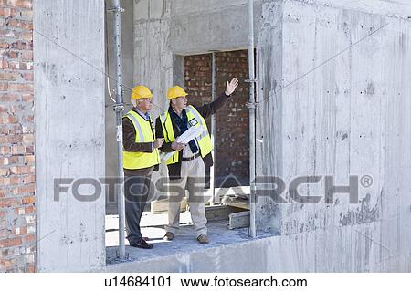 Businessman and worker talking on site View Large Photo Image Stock Image - Businessman and worker talking on site. Fotosearch