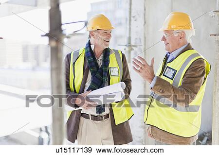 Businessman and worker talking on site View Large Photo Image Stock Photo - Businessman and worker talking on site. Fotosearch