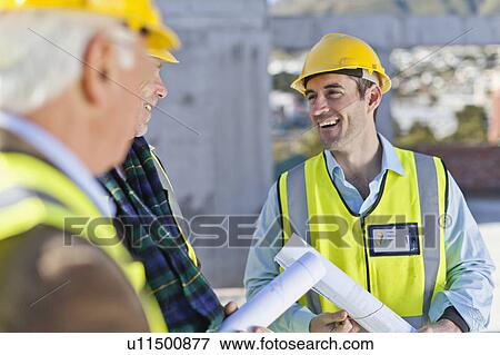 Stock Photo - Businessman and workers talking on site. Fotosearch