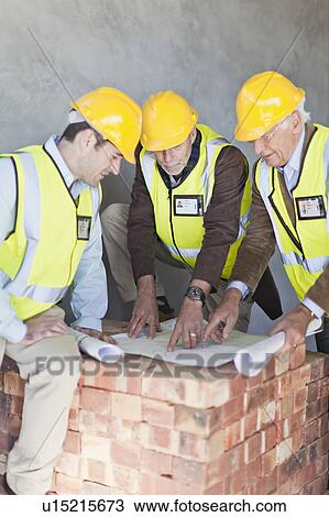 Businessman and workers with blueprints View Large Photo Image Stock Image - Businessman and workers with blueprints. Fotosearch