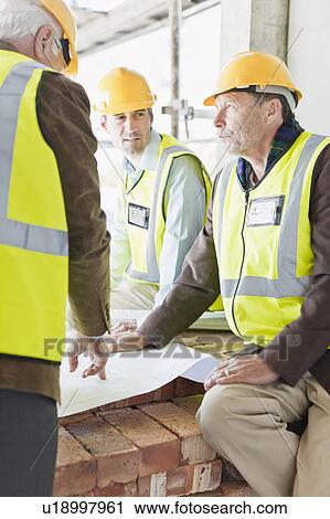 Businessman and workers with blueprints View Large Photo Image Stock Image - Businessman and workers with blueprints. Fotosearch