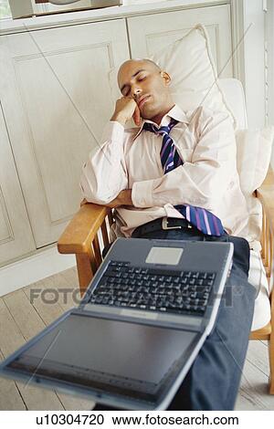 Businessman asleep with laptop at home View Large Photo Image Stock Image - Businessman asleep with laptop at home. Fotosearch