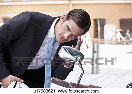 Businessman checking hair in side mirror View Large Photo Image Stock Image - Businessman checking hair in side mirror. Fotosearch