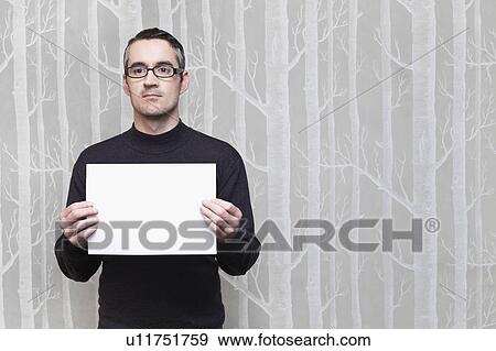 Stock Photo - Businessman holding blank card. Fotosearch