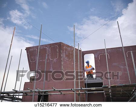 Businessman on shipbuilding site View Large Photo Image Stock Photo - Businessman on shipbuilding site. Fotosearch