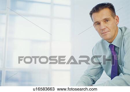Businessman sitting in office View Large Photo Image Stock Image - Businessman sitting in office. Fotosearch