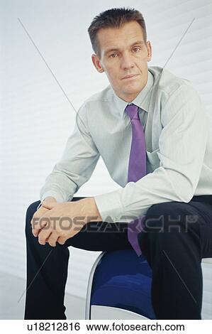 Stock Photograph - Businessman sitting on chair. Fotosearch