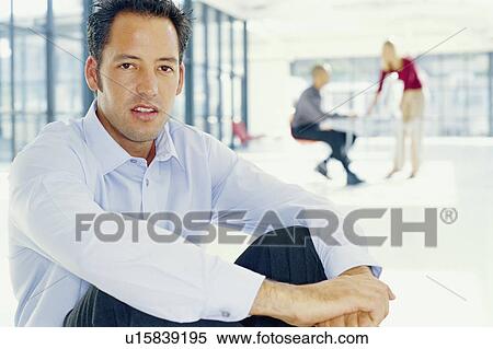 Stock Photography - Businessman sitting on office floor. Fotosearch