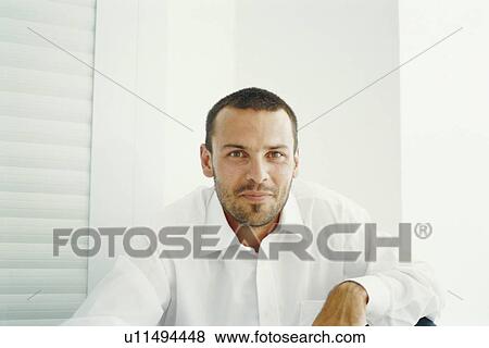 Businessman smiling in chair View Large Photo Image Stock Photo - Businessman smiling in chair. Fotosearch
