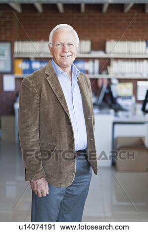 Businessman smiling in office View Large Photo Image Stock Image - Businessman smiling in office. Fotosearch