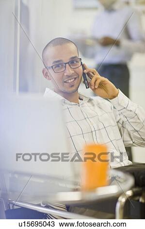 Businessman talking on cell phone View Large Photo Image Stock Image - Businessman talking on cell phone. Fotosearch