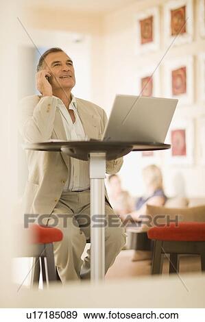 Stock Photo - Businessman talking on cell phone. Fotosearch