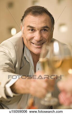 Businessman toasting with glass of wine View Large Photo Image Stock Photograph - Businessman toasting with glass of wine. Fotosearch