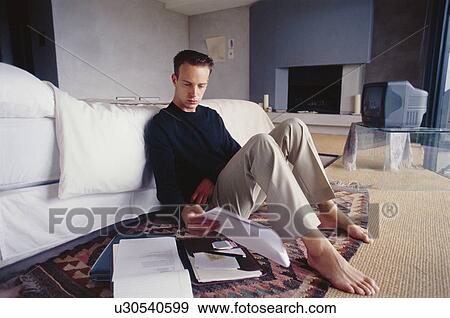 Stock Photo - Businessman working in bedroom. Fotosearch