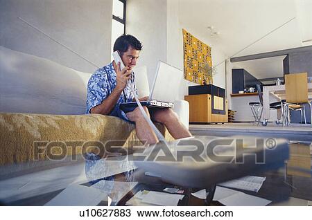 Businessman working in living room View Large Photo Image Stock Image - Businessman working in living room. Fotosearch