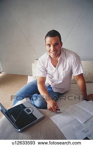 Businessman working on bed View Large Photo Image Stock Image - Businessman working on bed. Fotosearch