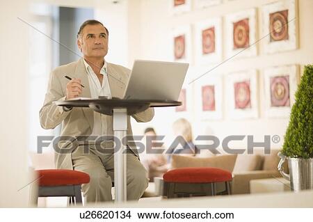 Businessman working on laptop View Large Photo Image Picture - Businessman working on laptop. Fotosearch