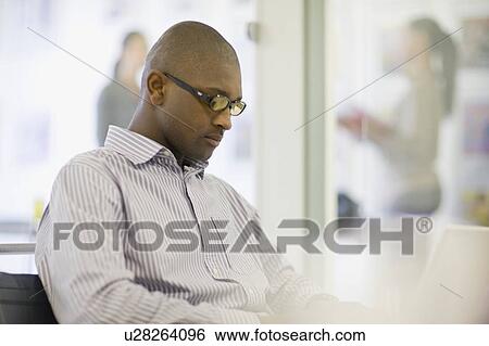 Businessman working on laptop View Large Photo Image Stock Photograph - Businessman working on laptop. Fotosearch