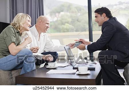 Picture - Businessman working with couple. Fotosearch
