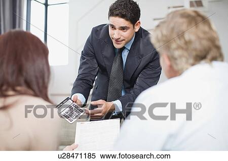 Businessman working with couple View Large Photo Image Stock Photography - Businessman working with couple. Fotosearch