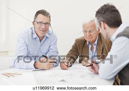 Stock Image - Businessmen talking in meeting. Fotosearch