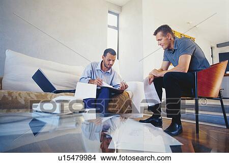 Businessmen working in living room View Large Photo Image Picture - Businessmen working in living room. Fotosearch