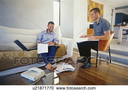 Businessmen working in living room View Large Photo Image Stock Image - Businessmen working in living room. Fotosearch