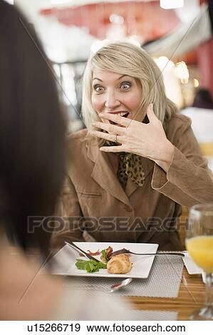 Stock Photo - Businesswoman laughing at lunch. Fotosearch