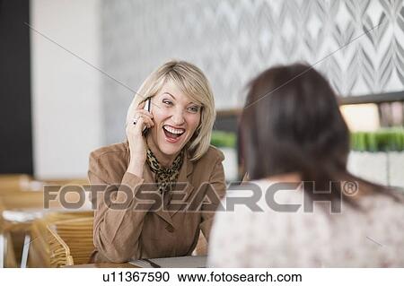 Businesswoman on cell phone at lunch View Large Photo Image Stock Image - Businesswoman on cell phone at lunch. Fotosearch