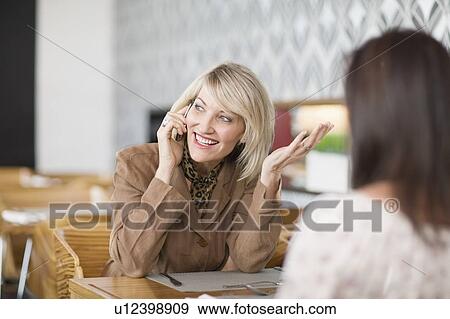 Businesswoman on cell phone at lunch View Large Photo Image Stock Photo - Businesswoman on cell phone at lunch. Fotosearch