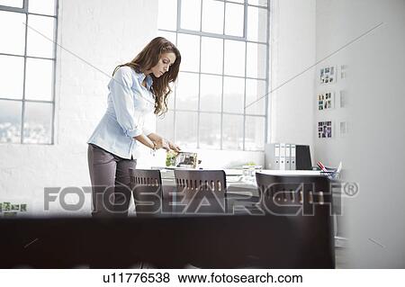 Businesswoman reading books in office View Large Photo Image Stock Photo - Businesswoman reading books in office. Fotosearch