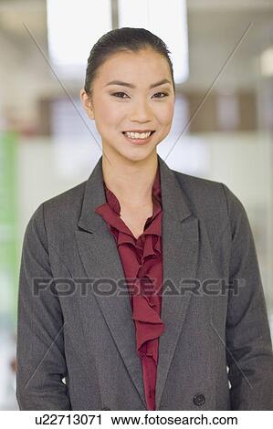 Businesswoman smiling in office View Large Photo Image Stock Image - Businesswoman smiling in office. Fotosearch