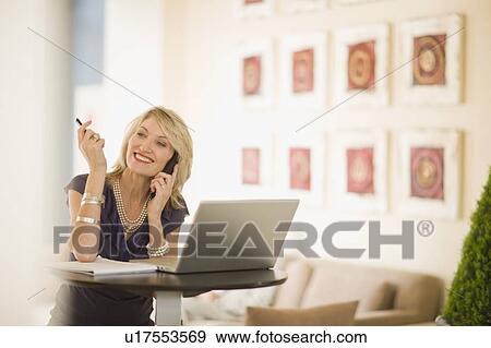Stock Photo - Businesswoman talking on cell phone. Fotosearch