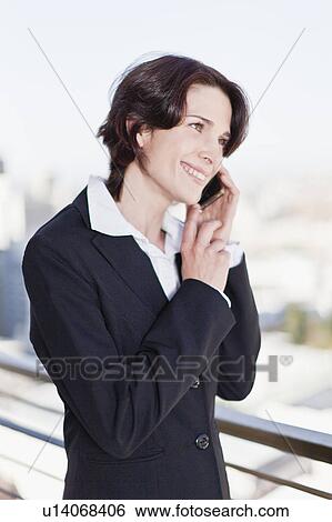 Businesswoman talking on cell phone View Large Photo Image Stock Photograph - Businesswoman talking on cell phone. Fotosearch