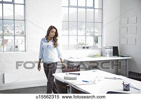 Stock Photography - Businesswoman walking in office. Fotosearch